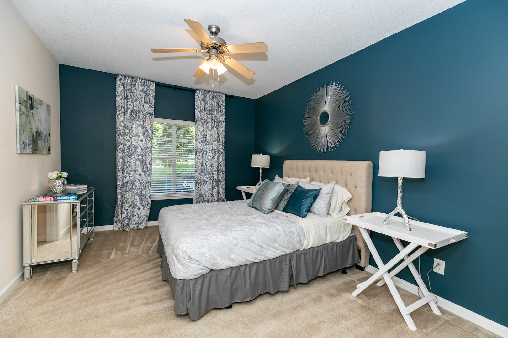 model carpeted bedroom with ceiling fan