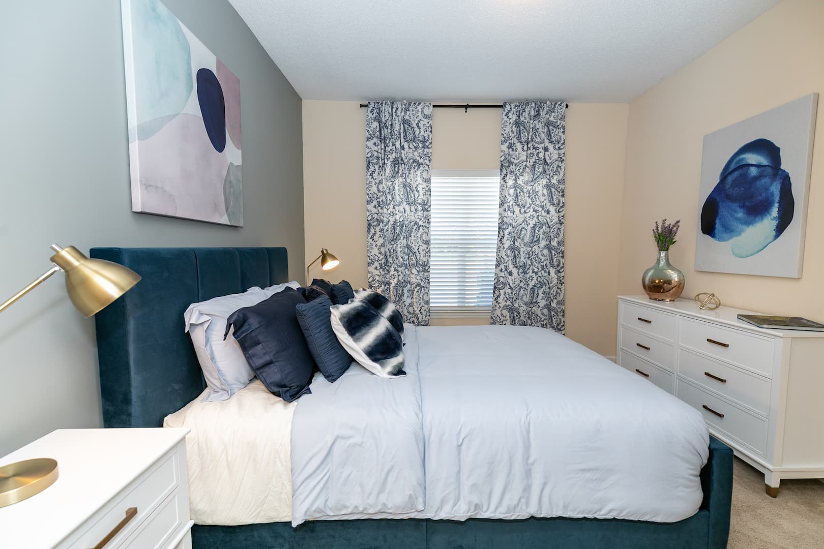 model carpeted bedroom with ample lighting