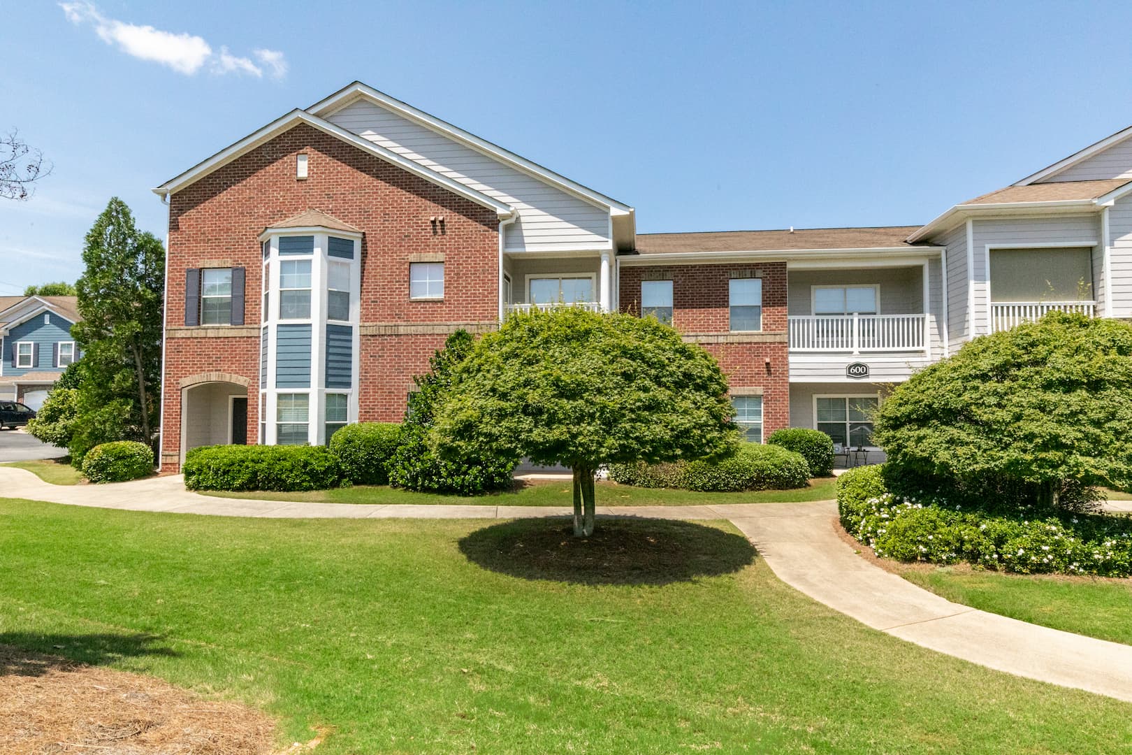 exterior view of apartment building and landscaping and walking path