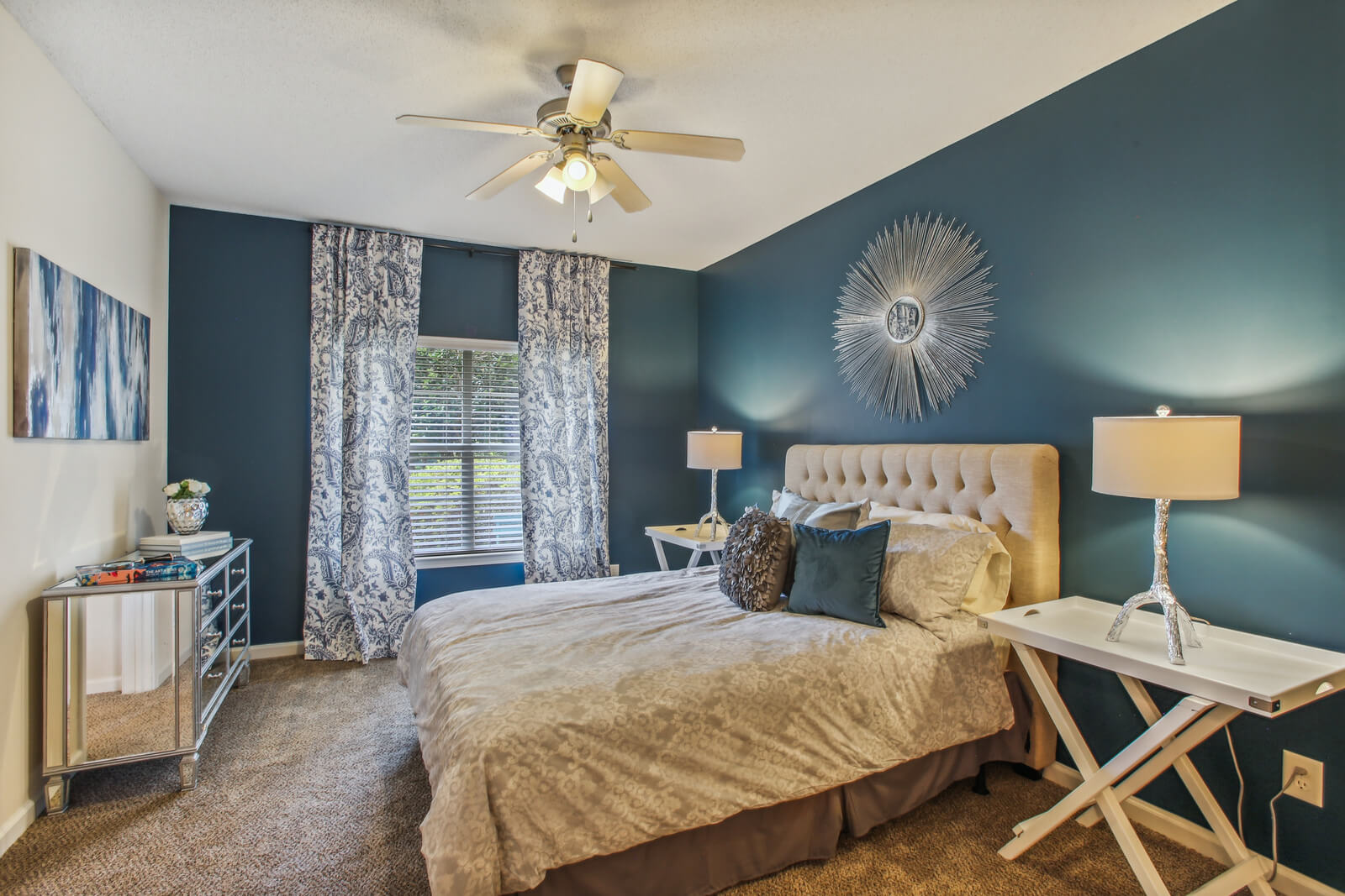 model carpeted bedroom with ceiling fan and ample lighting
