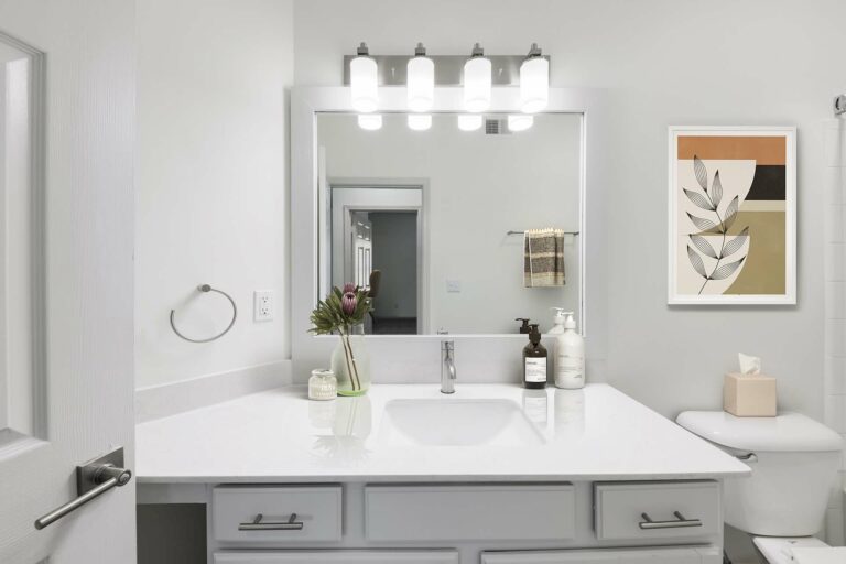 bathroom with white quartz counter and modern lighting