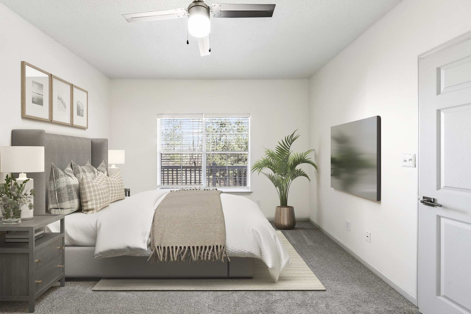 bedroom with large window and updated ceiling fan