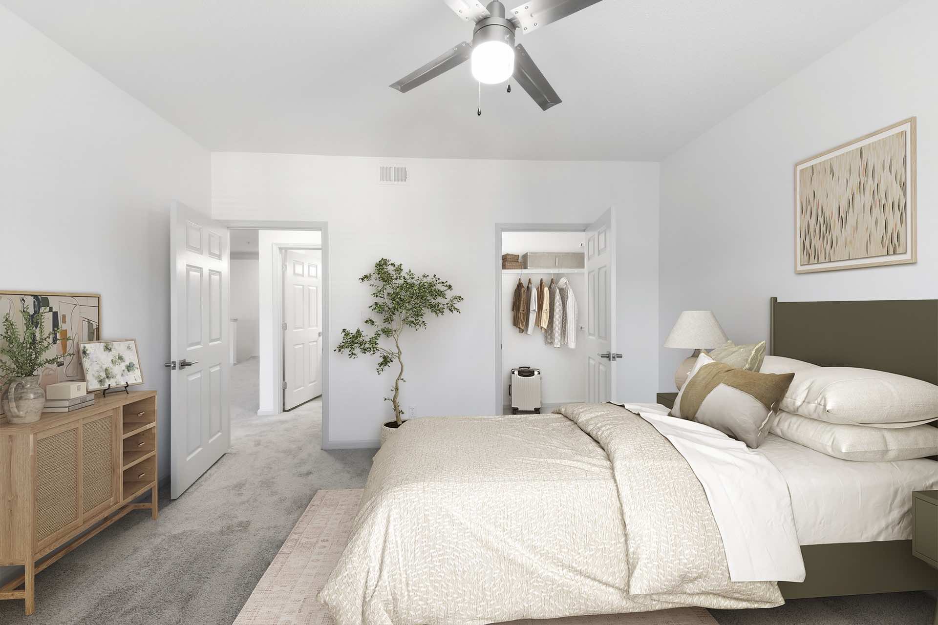 bedroom with large walk-in closet and updated ceiling fan