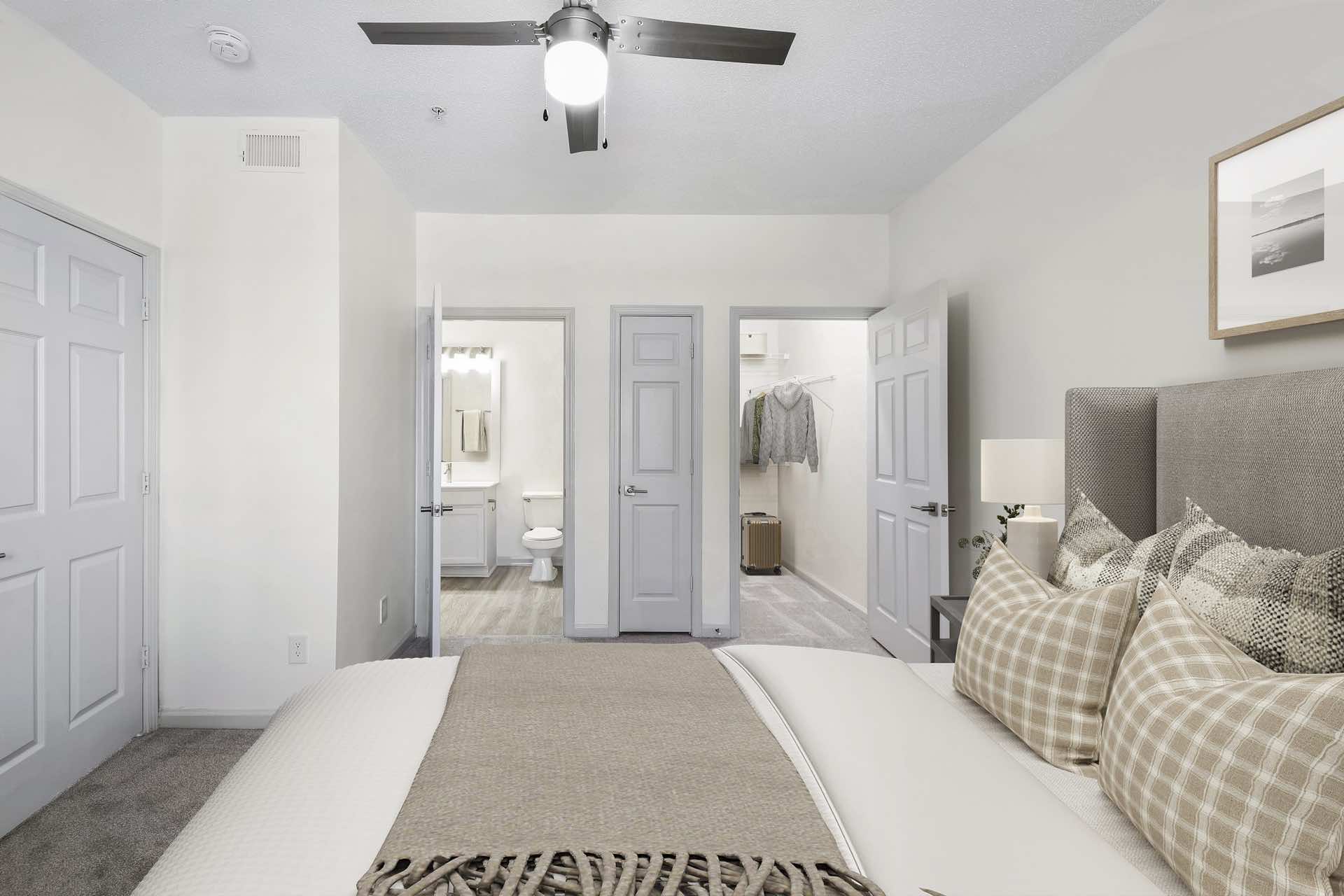 bedroom with doors leading to bathroom and spacious walk-in closet