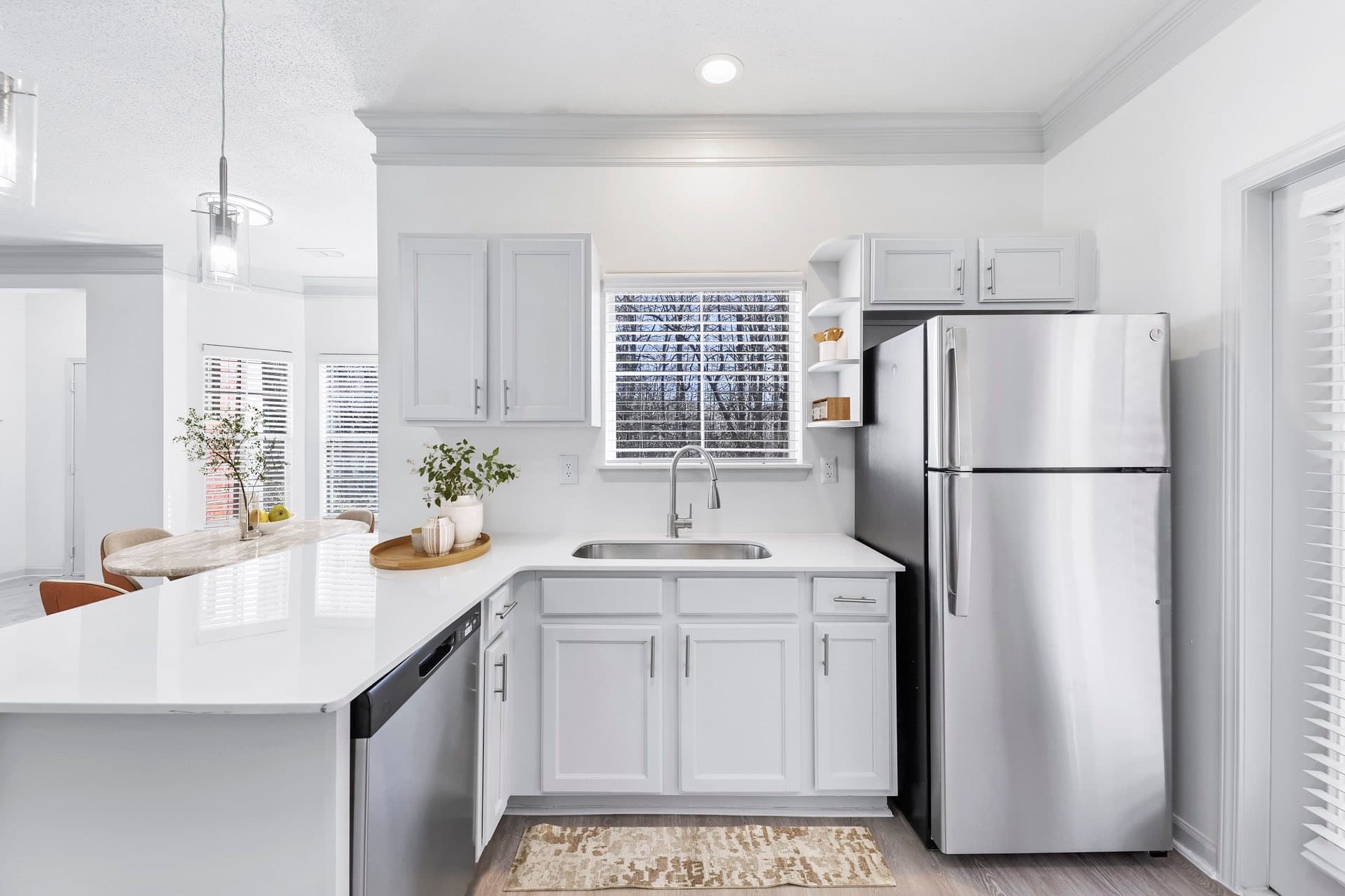 kitchen with large breakfast bar, gooseneck faucet and small window view of outdoors