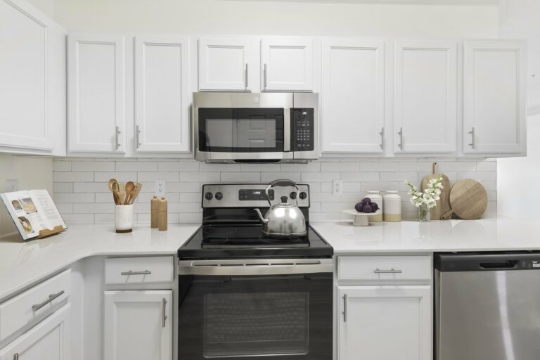 white shaker cabinets with brushed nickel accents in kitchen