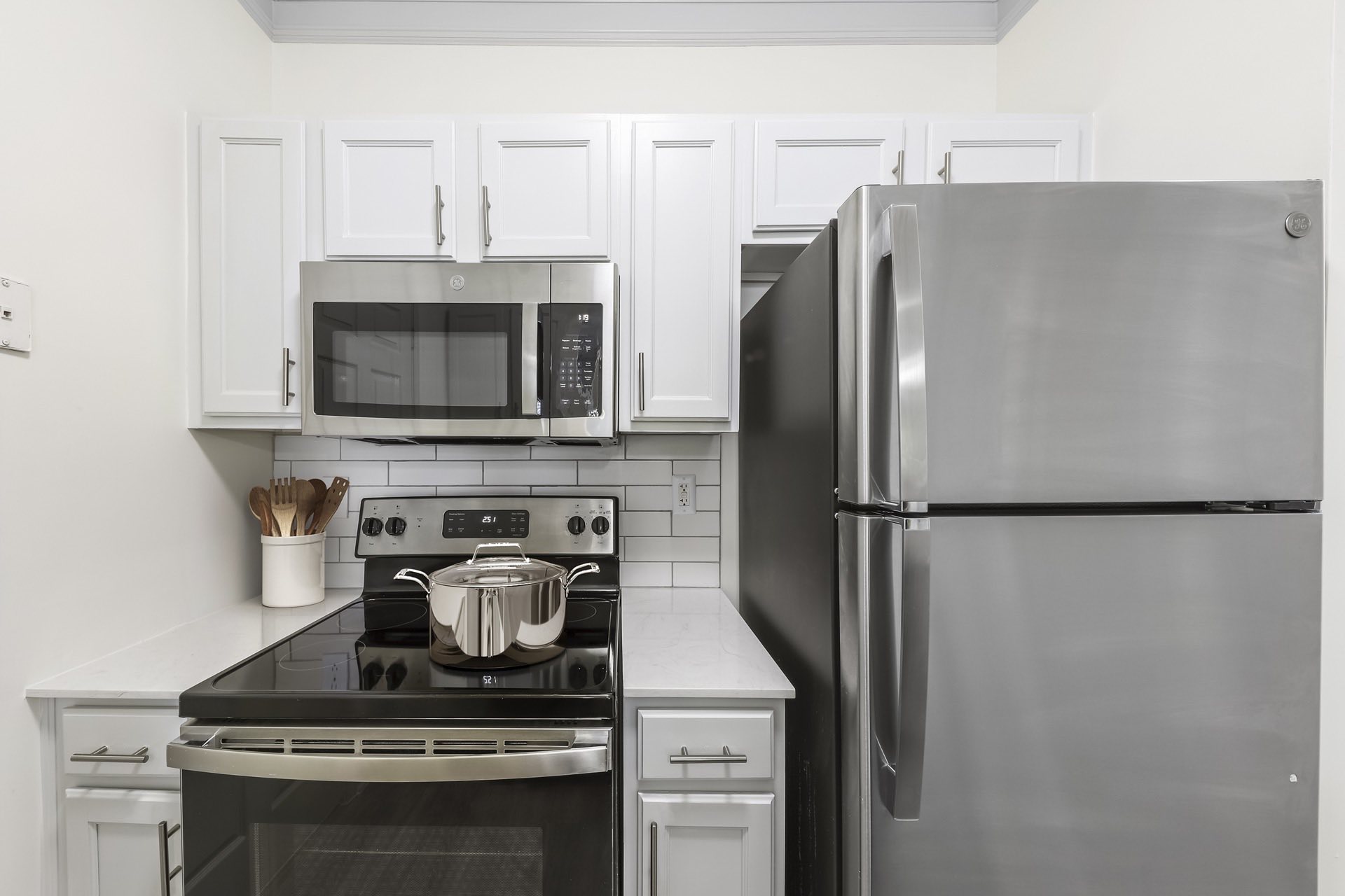 white shaker cabinets, stainless appliances and built-in microwave